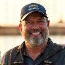 Pirili Jeewa smiling with a fishing rod